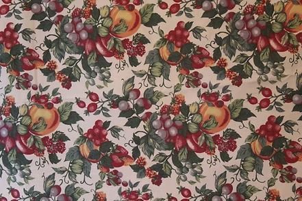 Floral and fruit-patterned fabric with roses, grapes, and leaves on a cream background