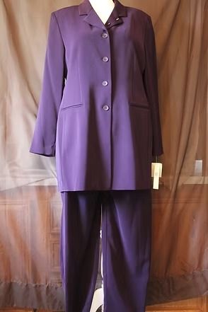 Purple women's pantsuit displayed on a mannequin against a wooden backdrop.