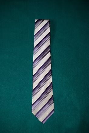 Striped necktie on a teal background.
