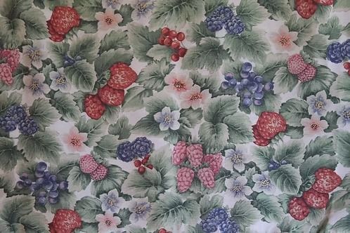 Floral fabric pattern with red, pink, and purple berries and green leaves
