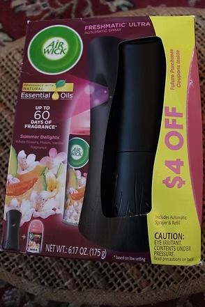 Air Wick Essential Mist refill with black diffuser, purple and yellow packaging, $4 off coupon
