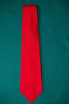 Red necktie on a teal background
