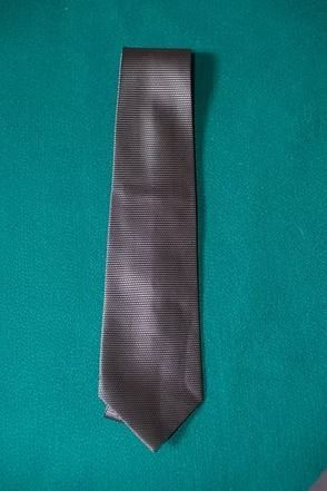 Gray striped necktie on a teal background