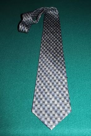 Patterned gray tie on a green background