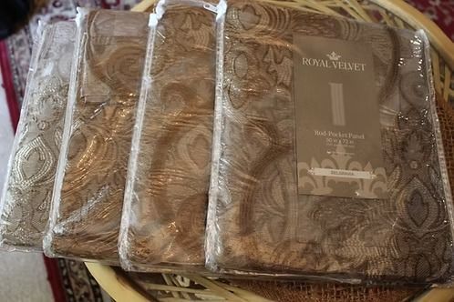 Wrapped brown patterned bedding set with a label on top on a table