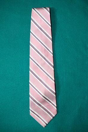 Pink striped necktie on a teal background