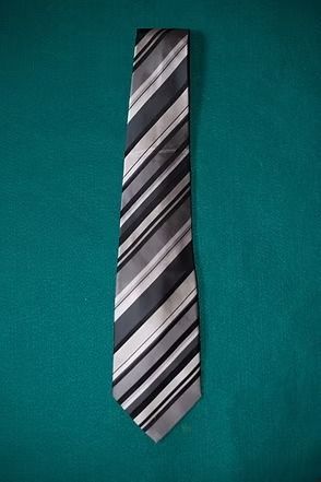 Black-and-silver striped necktie on a teal background