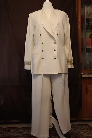 Cream double-breasted suit with wide-leg trousers displayed on a mannequin indoors