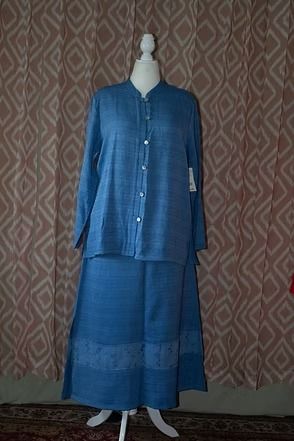 Blue tunic and skirt outfit displayed on a mannequin against a patterned backdrop