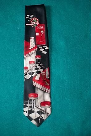 Black and red necktie with a checkered bar scene and red barstools on a teal background