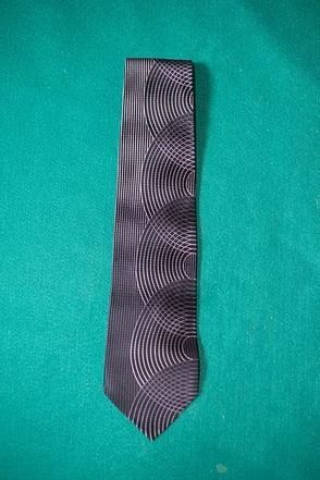 Black patterned necktie on a teal background