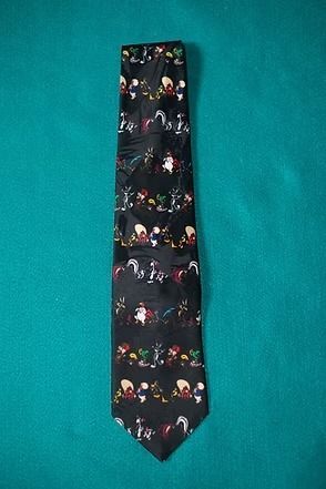 Black tie with colorful small figures on a teal background