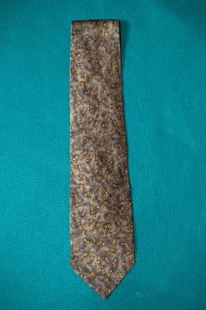 Brown patterned necktie on a teal background