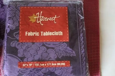 Packaged Harvest purple floral fabric tablecloth with red label