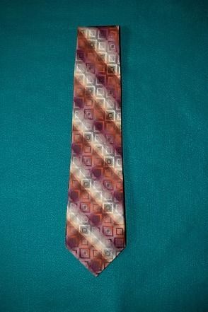 Patterned tie on a teal background