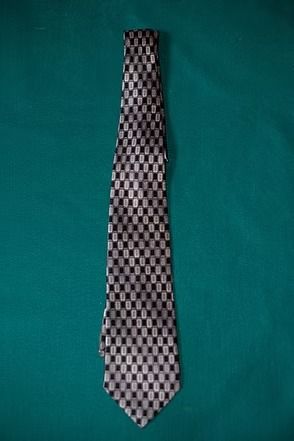 Black-and-white checkered necktie on a teal background