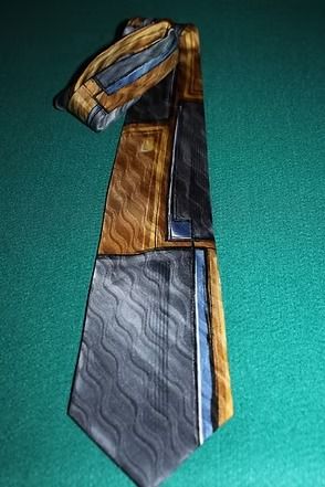 Packaged Arrow necktie in blue, gold, and gray with green price sticker 431