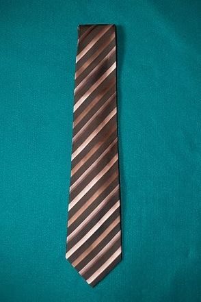 Brown striped necktie on a teal background