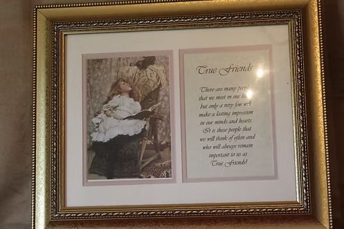 Framed photo and poem on a wall, with a gold ornate border.