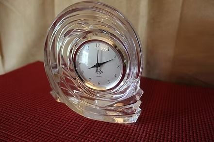 Glass desk clock on a red textured surface