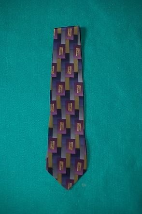 Purple geometric patterned necktie on a teal background