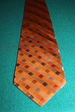Orange checkered necktie on a teal background