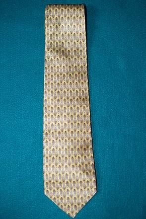Beige patterned necktie on a blue background
