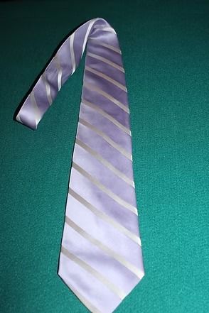Light purple striped necktie on a green textured background