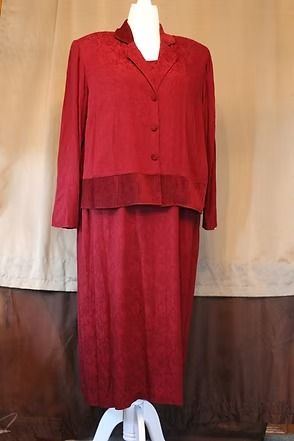 Red long-sleeve jacket and matching skirt on a mannequin against a tan backdrop.