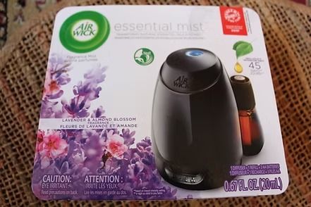 Air Wick Essential Mist diffuser box with lavender flowers and a black dispenser on a white background