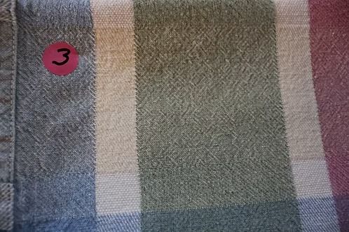 Close-up of a plaid fabric with a pink circle labeled “3” in the top left.