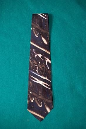 Brown patterned necktie on a green background