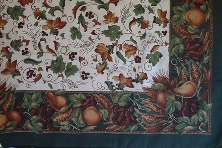 Decorative floral and fruit-patterned fabric border in green, red, and gold tones