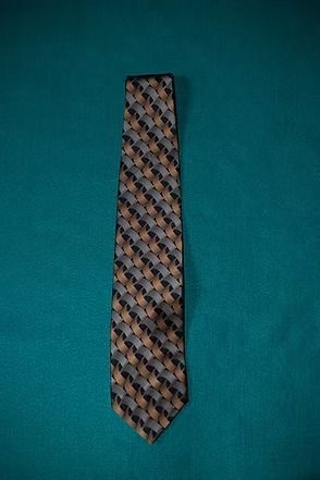 Patterned necktie on a teal background