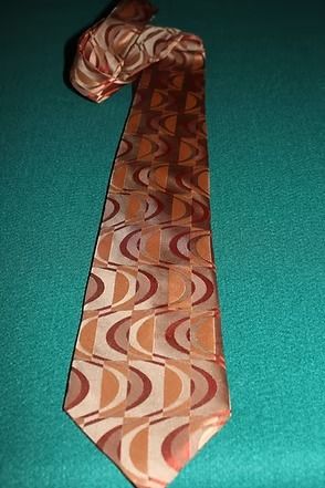 Patterned brown tie on a teal background.