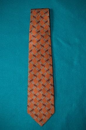 Orange patterned necktie on a teal background
