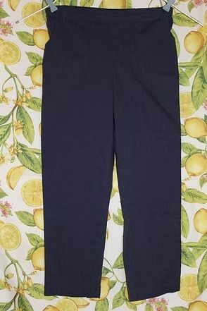 Dark navy pants laid flat on a patterned surface.