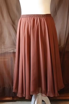 Dusty rose pleated midi skirt on a mannequin against a neutral backdrop