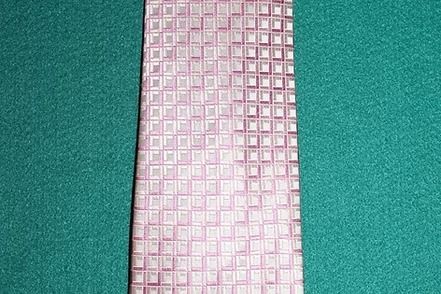 Pink checkered fabric strip on green background