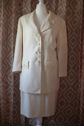 Cream-colored women’s suit jacket and skirt displayed on a mannequin
