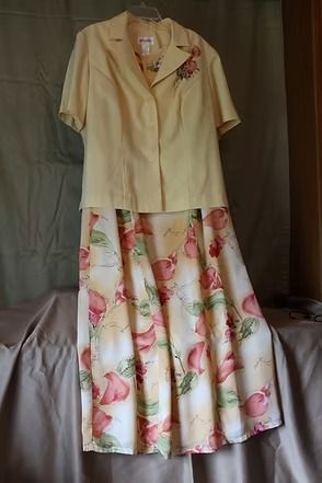 Cream short-sleeve blouse with floral skirt displayed on a hanger