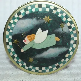 Angel flying through a starry sky in a round checkerboard-framed artwork