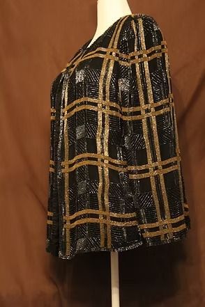 Black and gold plaid jacket on a mannequin against a brown backdrop