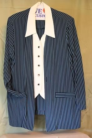 Navy pinstripe blazer over a white collared shirt on a hanger, front view