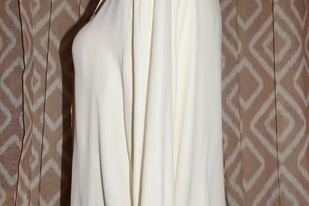 Close-up of a white curtain with vertical folds and seams