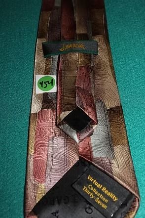 Patterned necktie with brown, tan, white, and red geometric shapes on a teal background