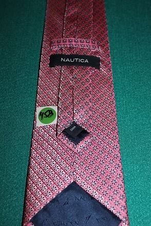 Red patterned necktie on a green background