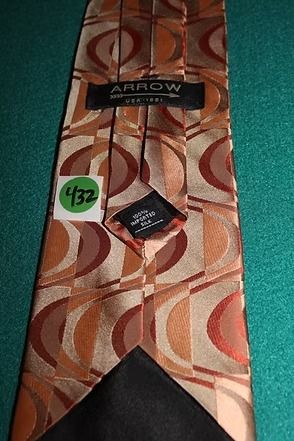 Patterned brown tie on a teal background.