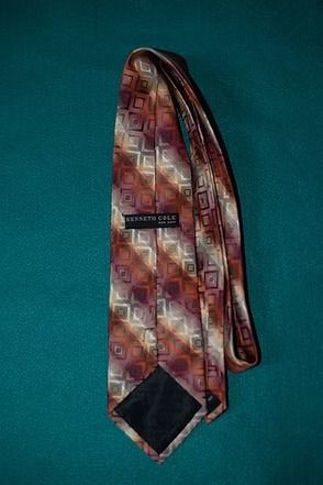 Patterned tie on a teal background