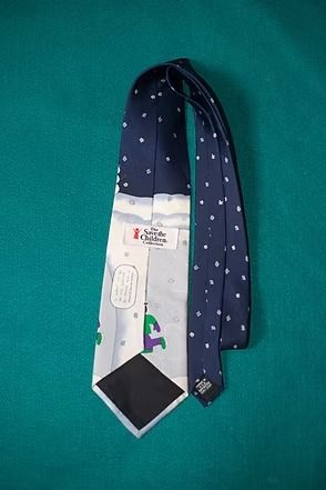 Winter scene on a blue necktie, with snowmen, children sledding, and a bright sun in the sky